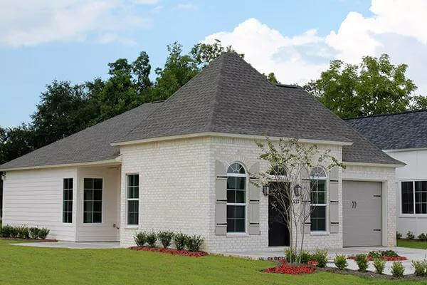 Front-left view with a sleek entry, a single garage, and a side porch.