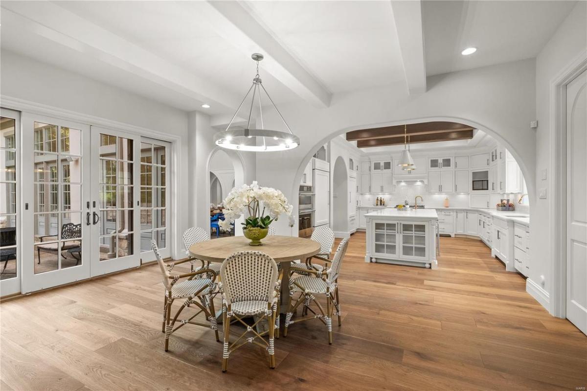 Breakfast nook with a round wood table.