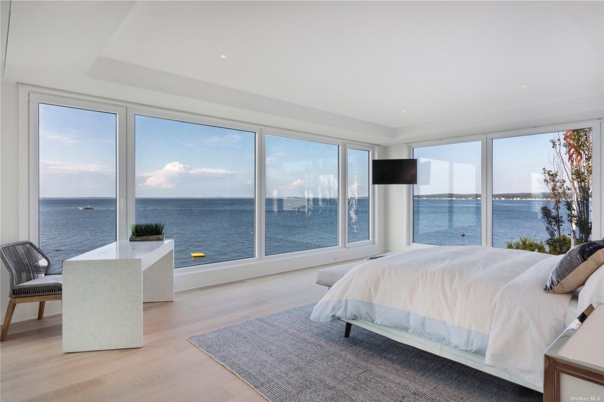 Bedroom with hardwood flooring and glass walls.