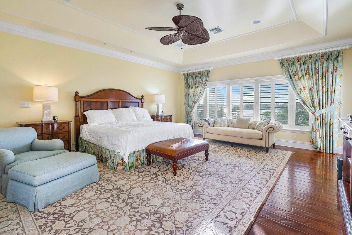 Bedroom with a large bed and hardwood flooring.