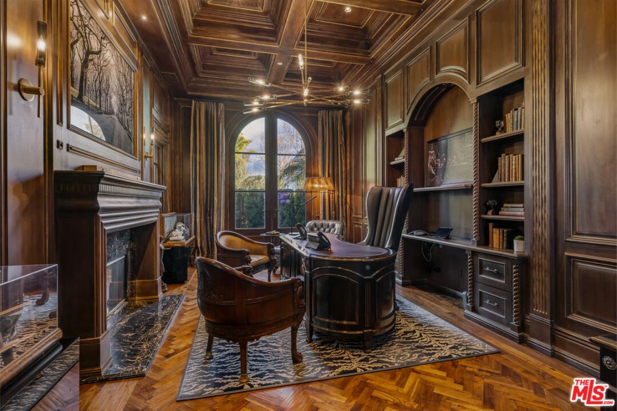 Home office with coffered ceiling and a fireplace.