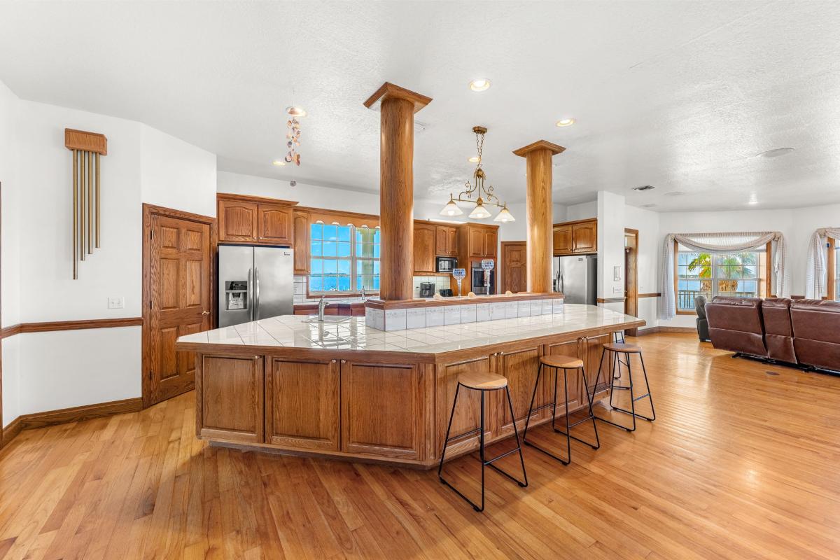Kitchen with a breakfast counter and an oak hardwood cabinetry.