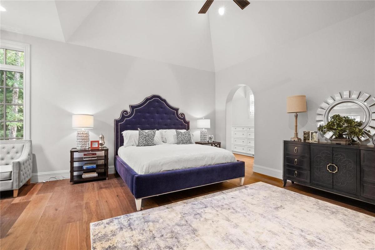Bedroom with a large bed and hardwood floors.