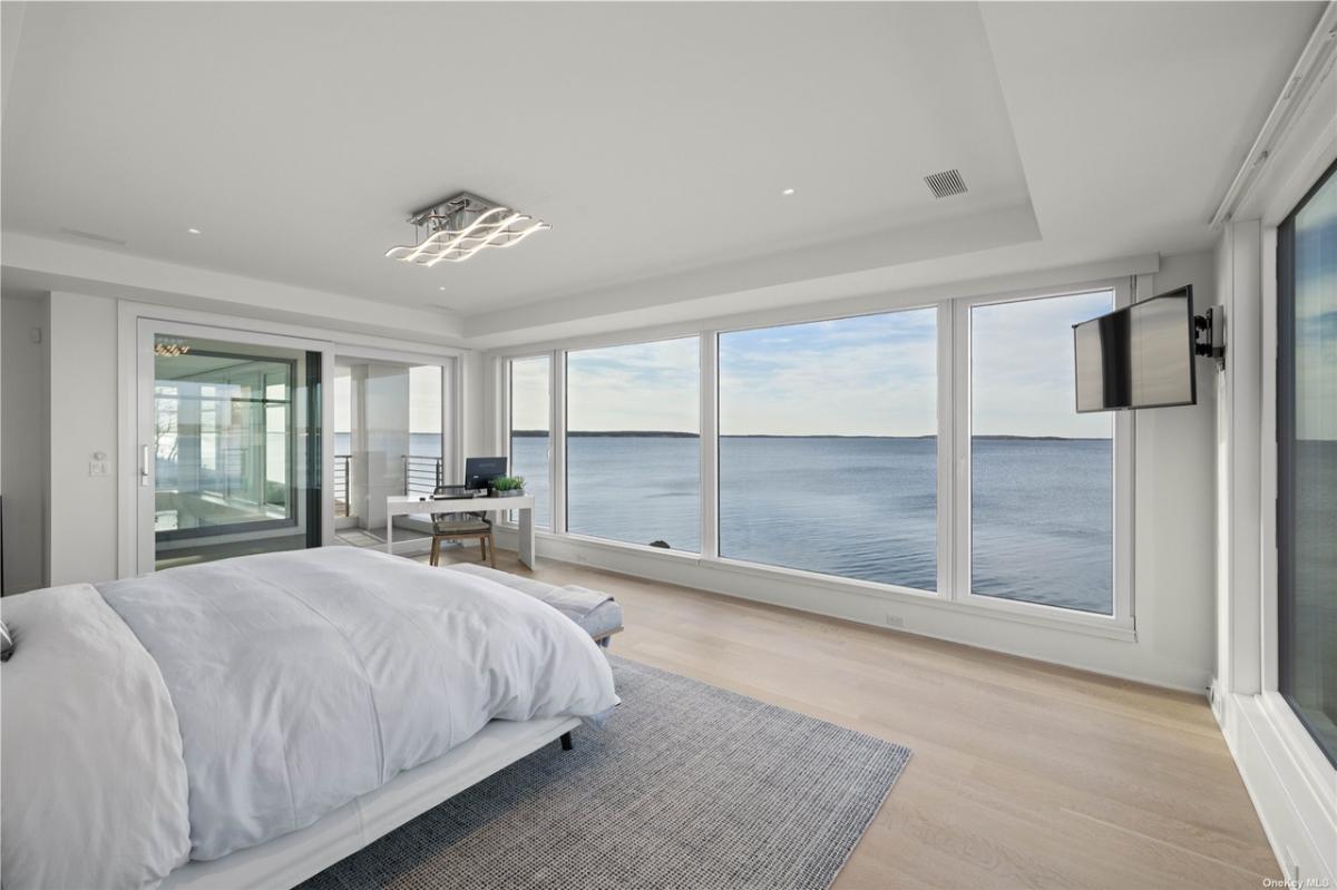 Bedroom with hardwood flooring and glass walls.