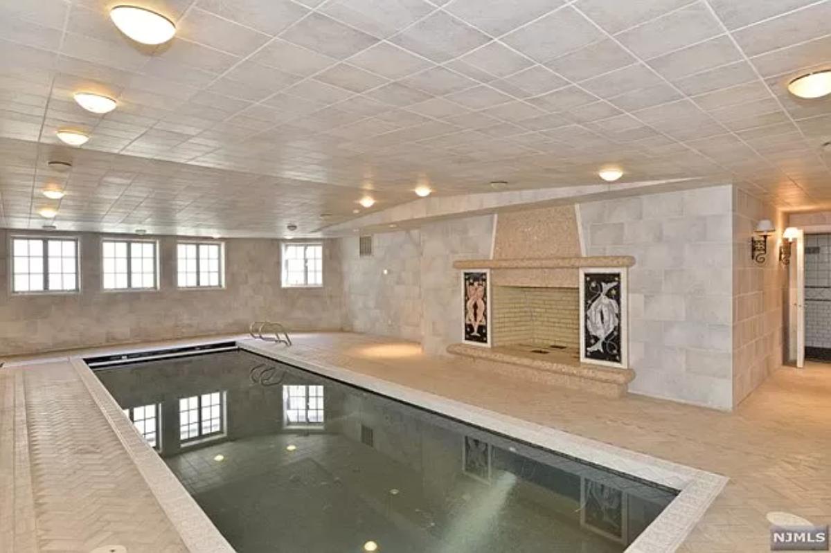 Indoor pool with a fireplace.