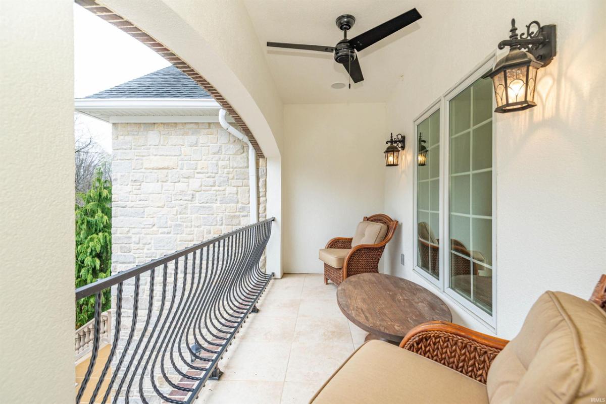 Balcony with a table and chairs.