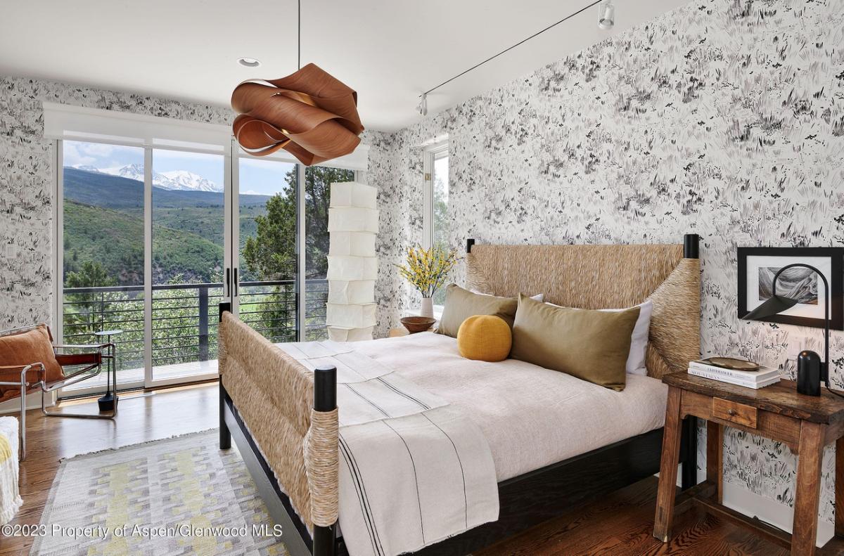 Bedroom with hardwood floor and sliding glass door.