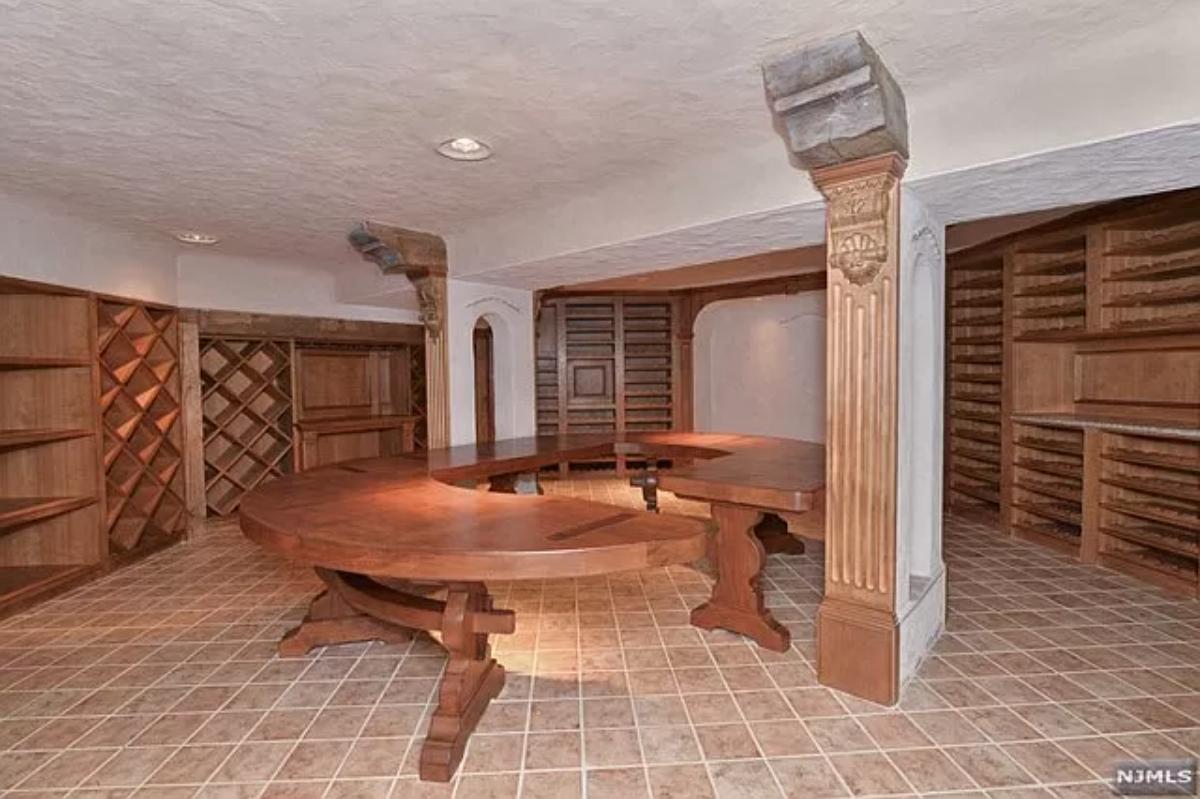 Wine cellar with a wood table.