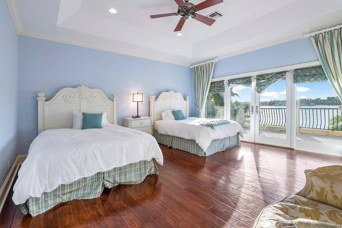 Bedroom with hardwood flooring and glass doors.