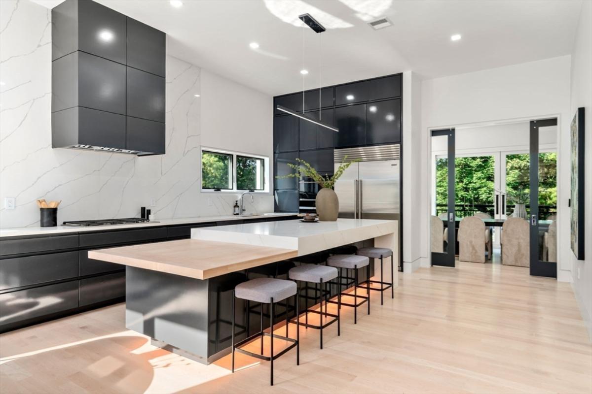 Kitchen with a a spacious granite counter breakfast bar and island prep area.
