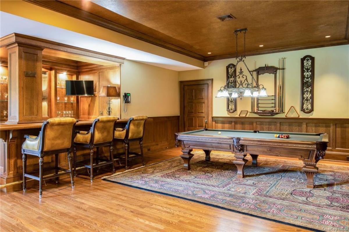 Recreational room with a billiards table and a bar.