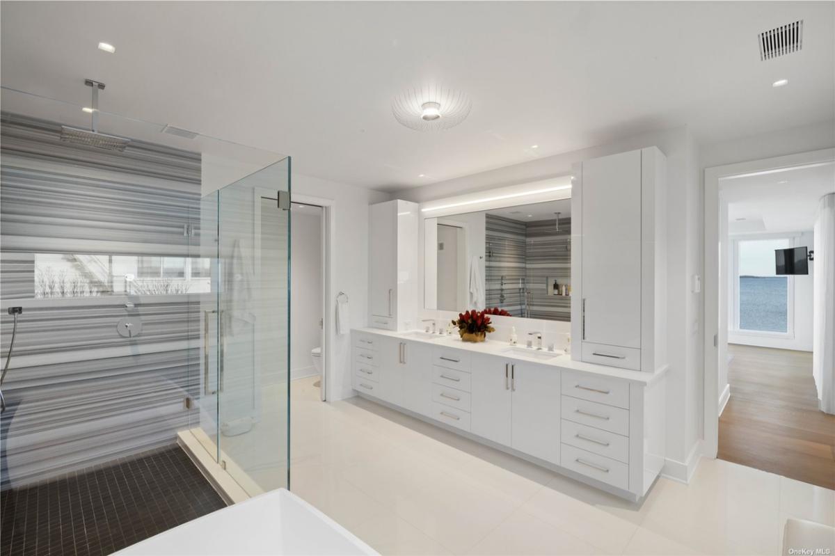 Bathroom with a custom-made vanity and a walk-in shower.