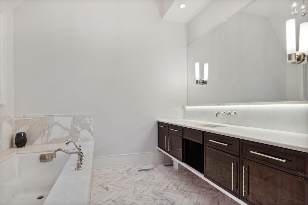 Bathroom with a sink and a soaking tub.