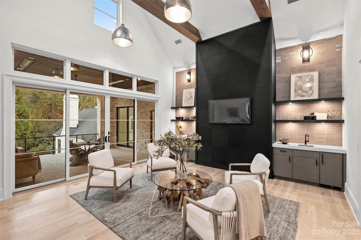Media room with a TV, glass table and chairs.
