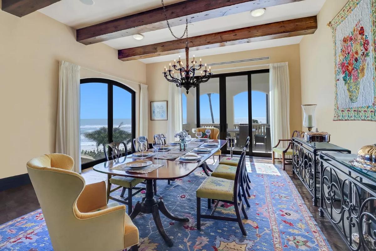 Dining room with a chandelier and glass doors.