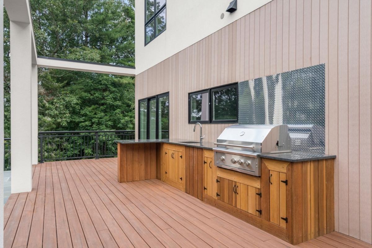 Outdoor kitchen with a sink and a grill.