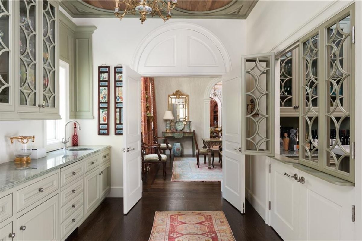 A kitchen with countertop, sink, and cabinets.