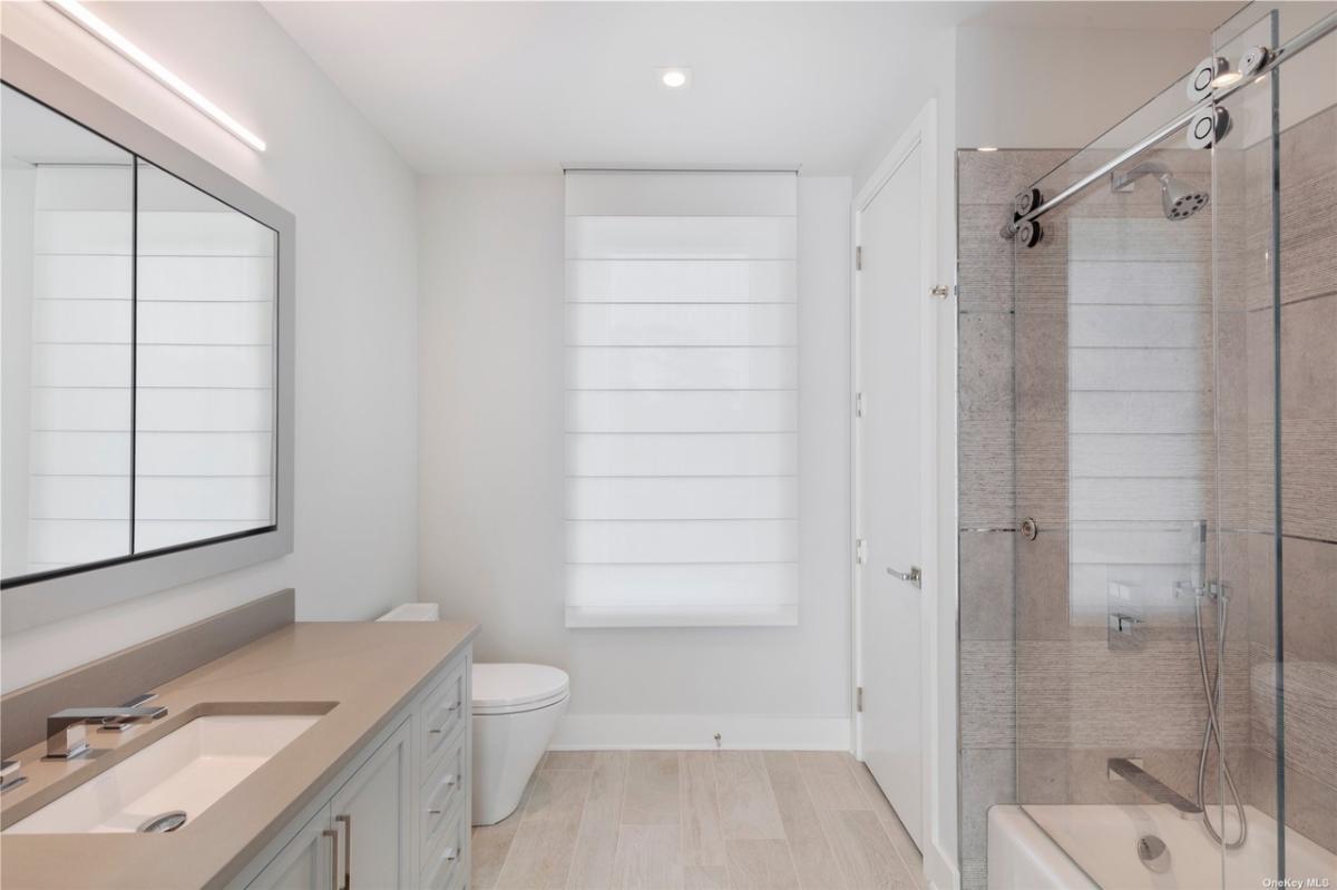 Bathroom with a sink, toilet and a walk-in shower.