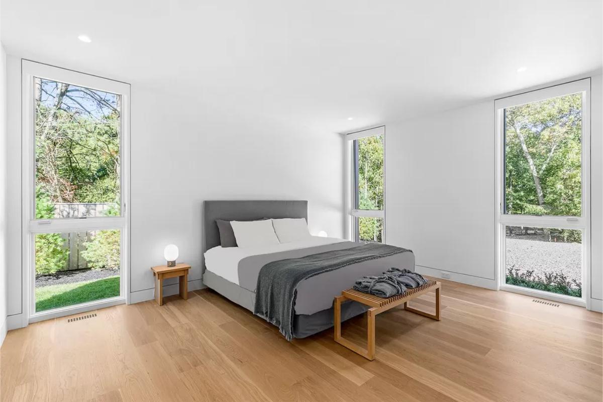 Bedroom with a hardwood floor and glass windows.