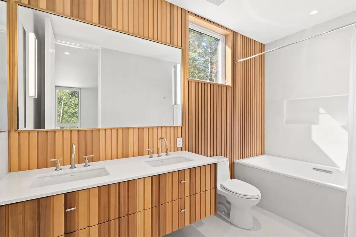 Bathroom with sinks, soaking tub and a toilet.