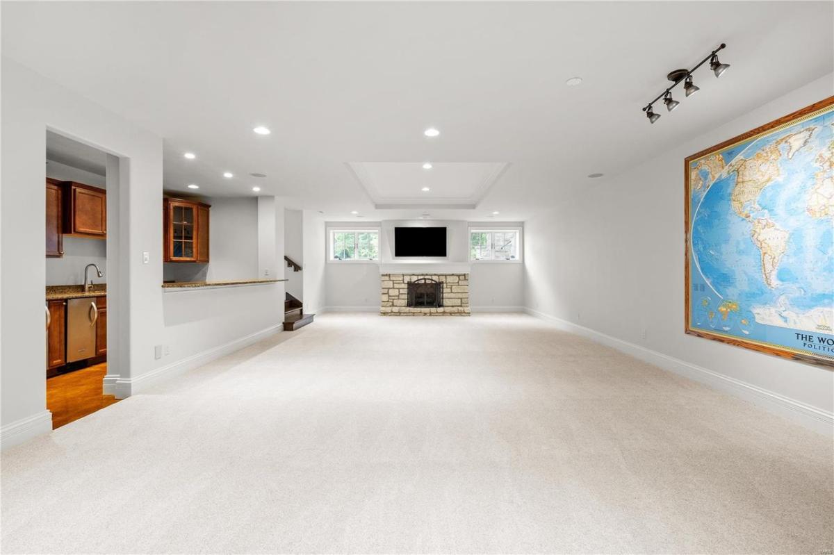 Family room with carpet flooring and a fireplace.