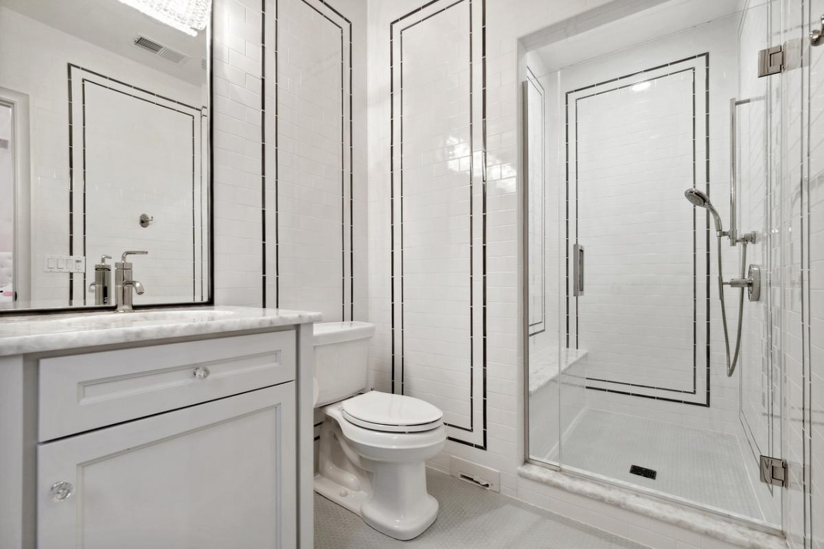 Bathroom with a sink, toilet and a walk-in shower.