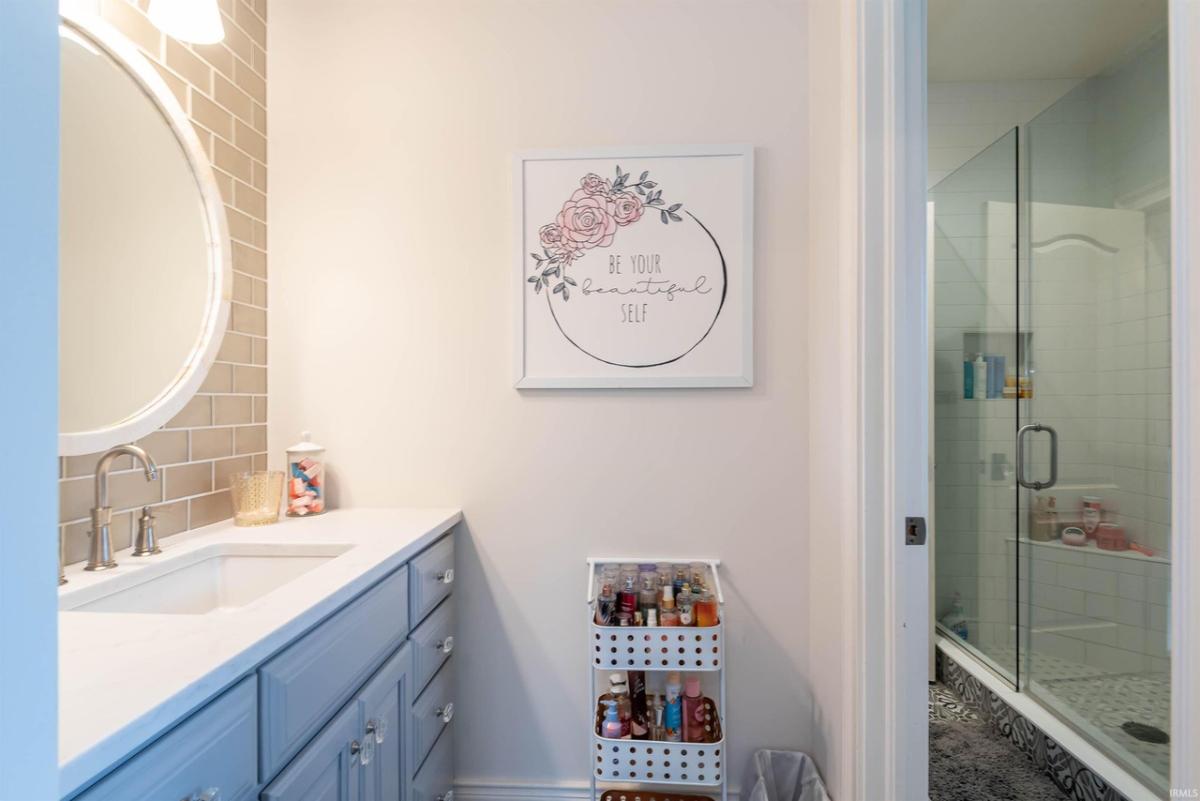 Bathroom with a sink and a walk-in shower.