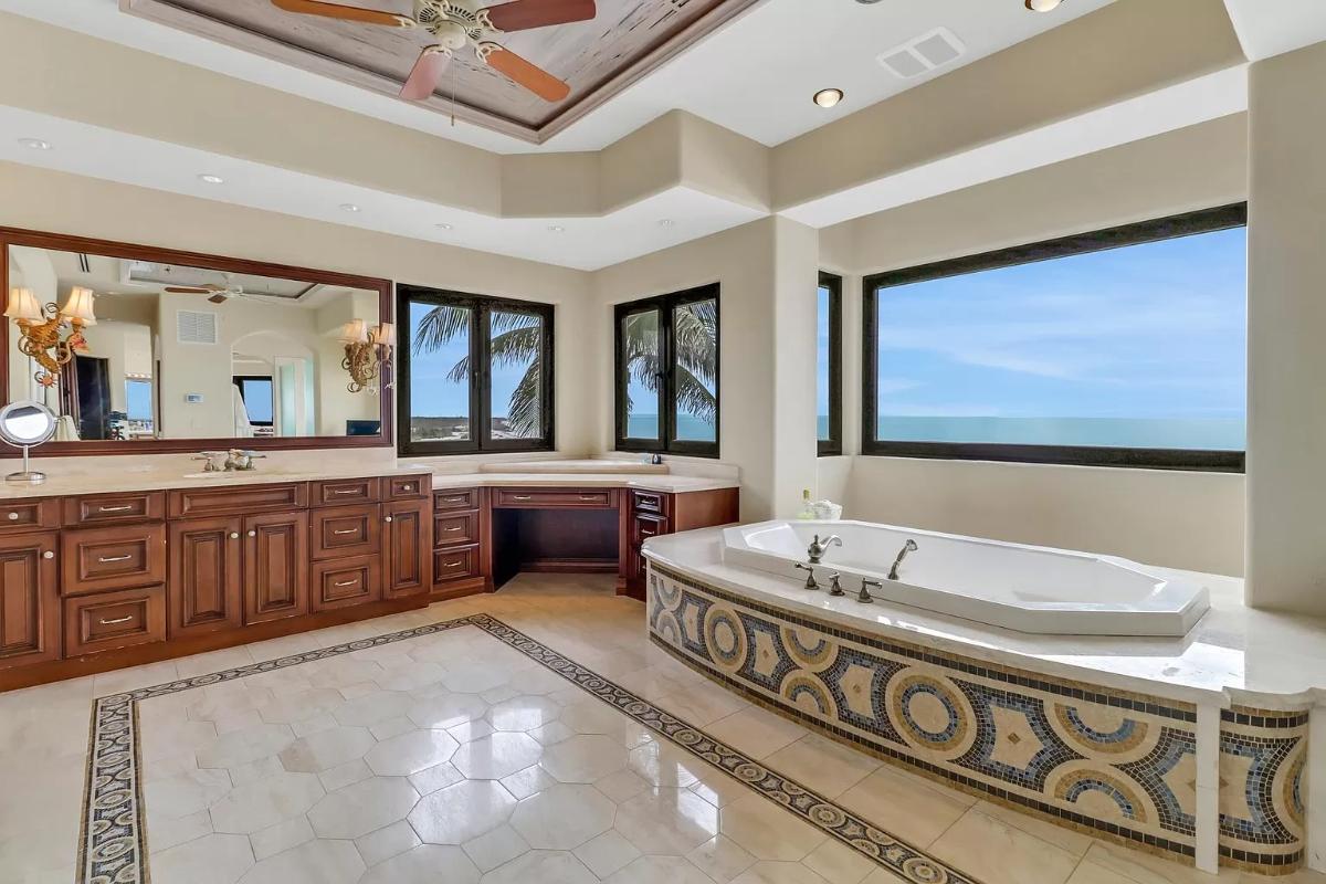Bathroom with custom-made vanities and a soaking tub.