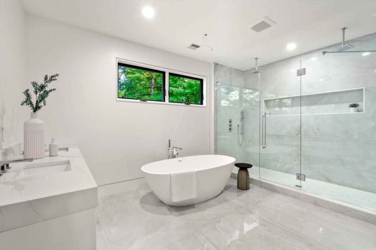 Bathroom with a sink, soaking tub and a walk-in shower.