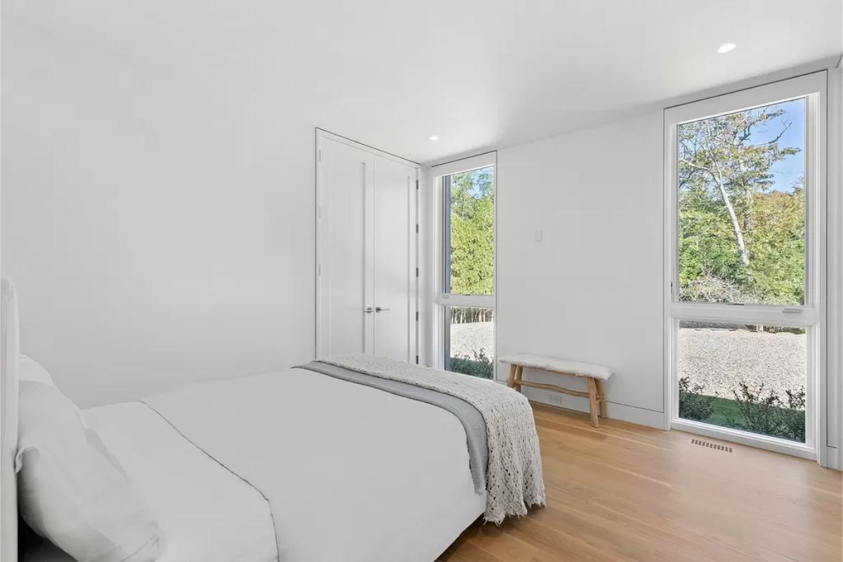 Bedroom with a hardwood floor and glass windows.