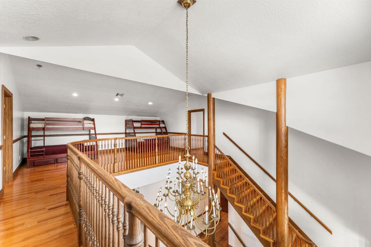 Landing with bunks and a chandelier.