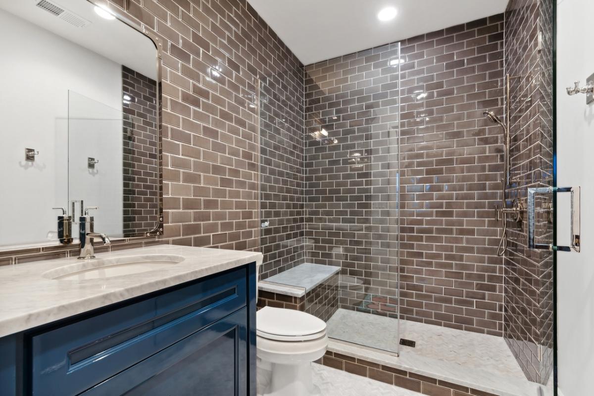 Bathroom with a sink, toilet and a walk-in shower.