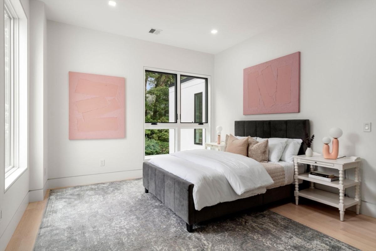 Bedroom with hardwood flooring and glass windows.