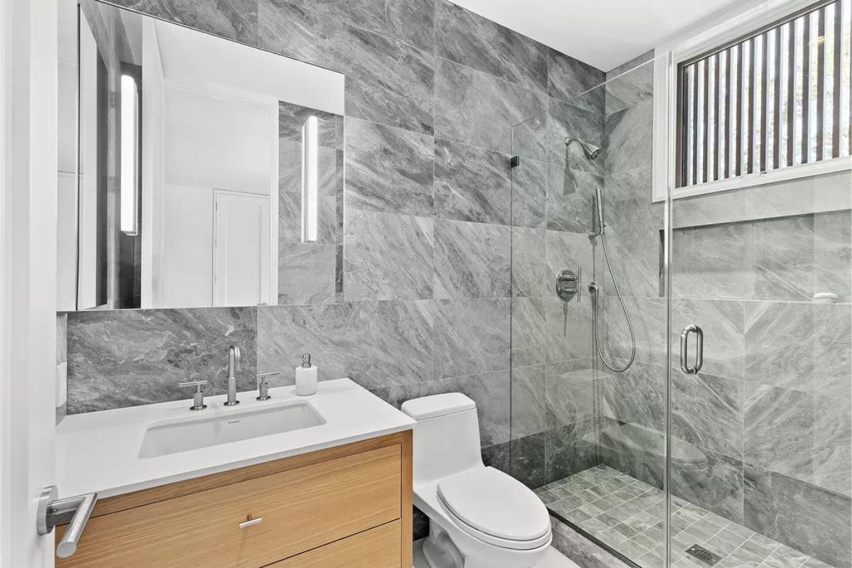 Bathroom with a sink, toilet and a walk-in shower.
