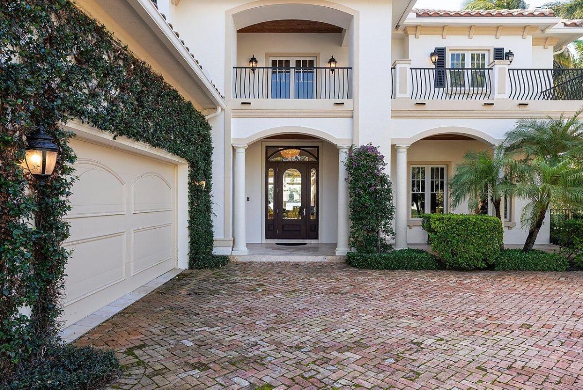 Front entry of the mansion with a wood & glass door.