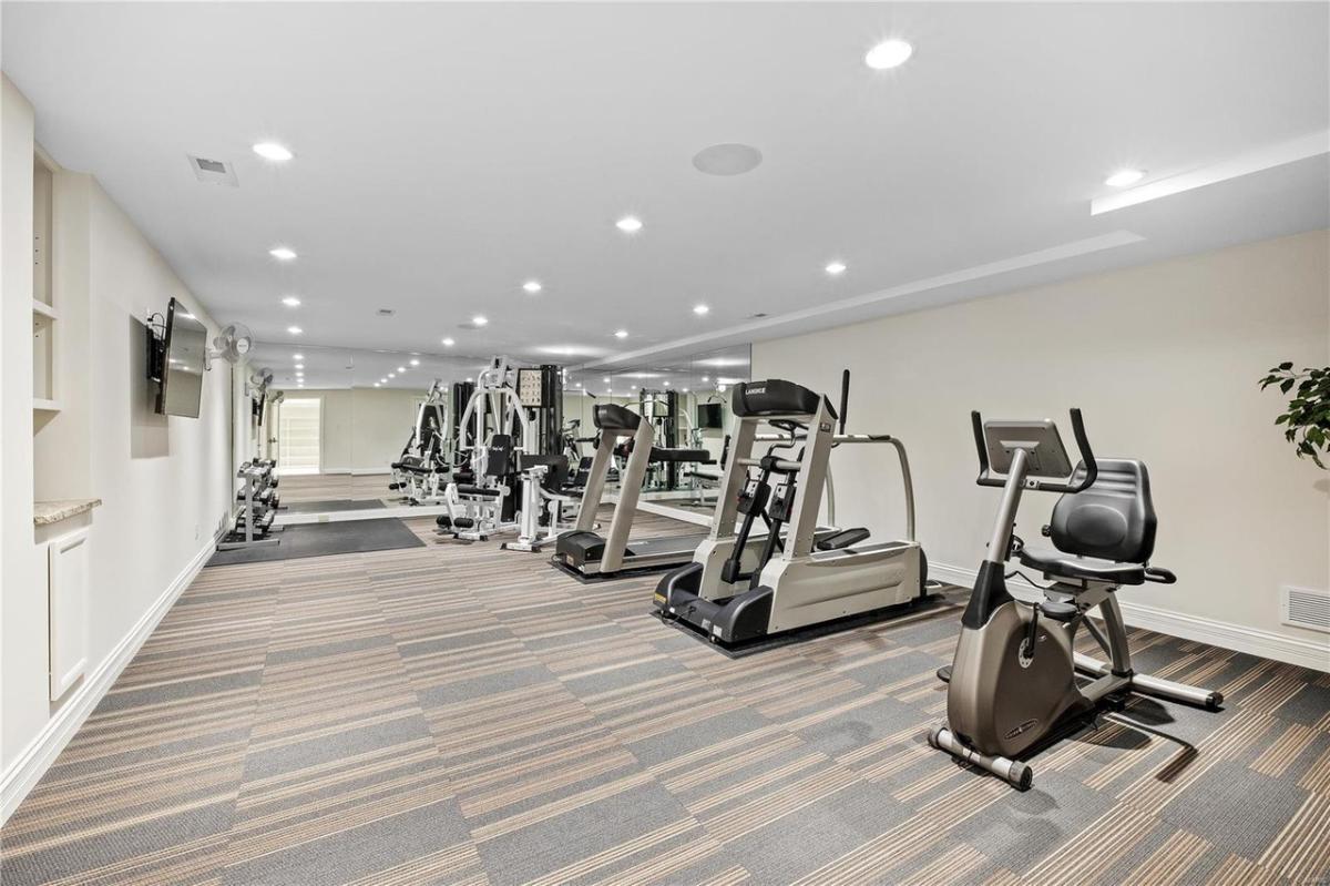 Home gym with lots of workout equipment.