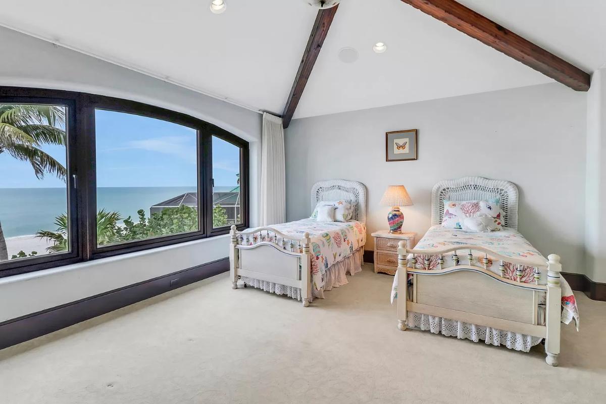 Bedroom with two beds and carpet flooring.