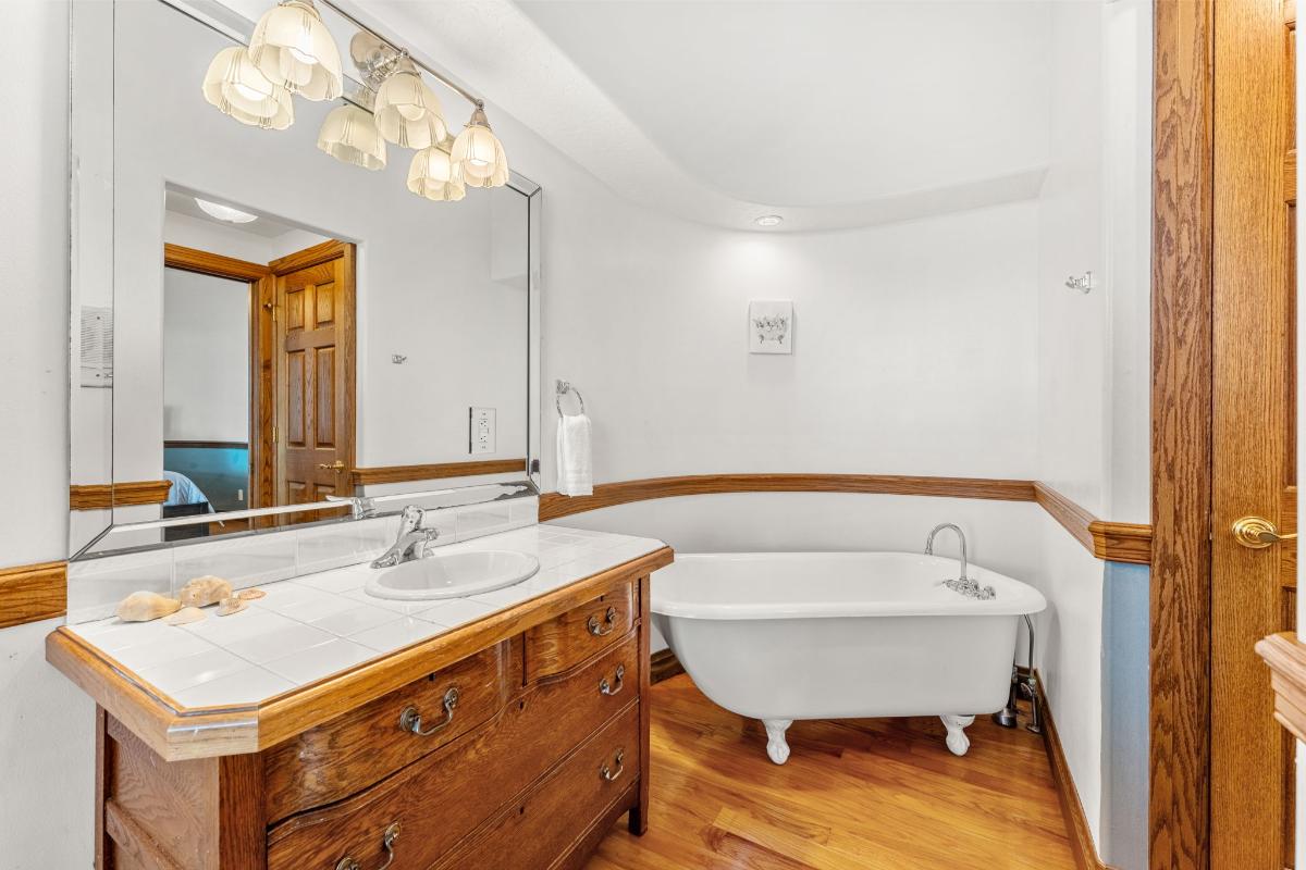 Bathroom with a bathtub and a vanity.
