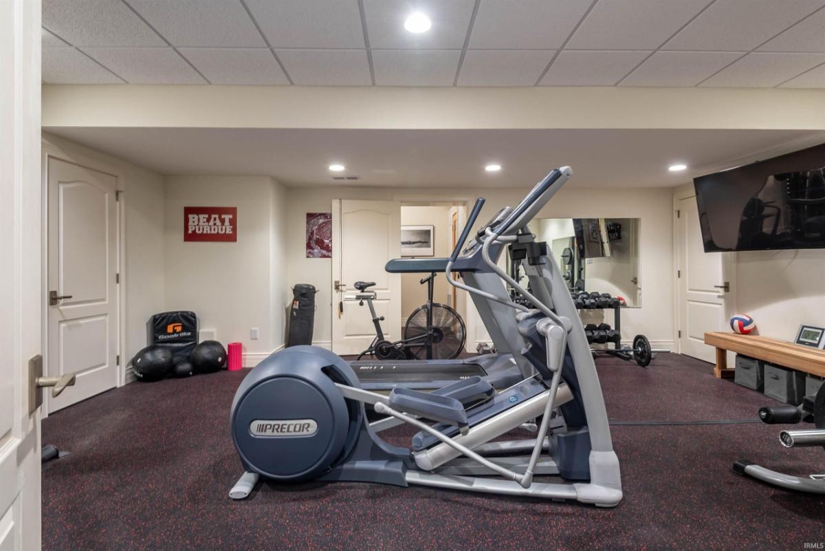 Home gym with carpet flooring.