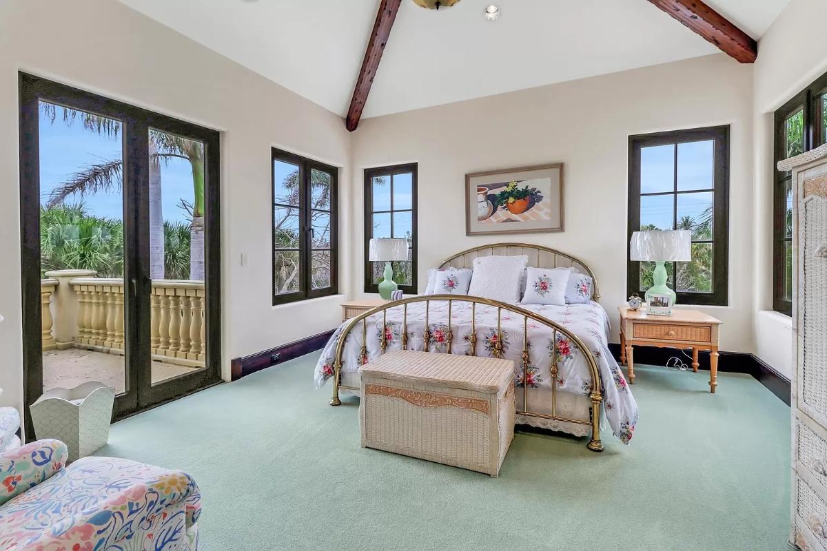 Bedroom with glass doors and carpet flooring.