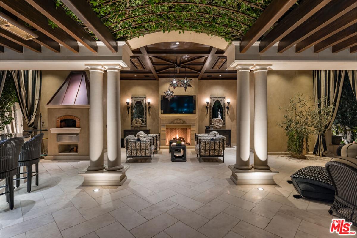 Outdoor living space with a fireplace.
