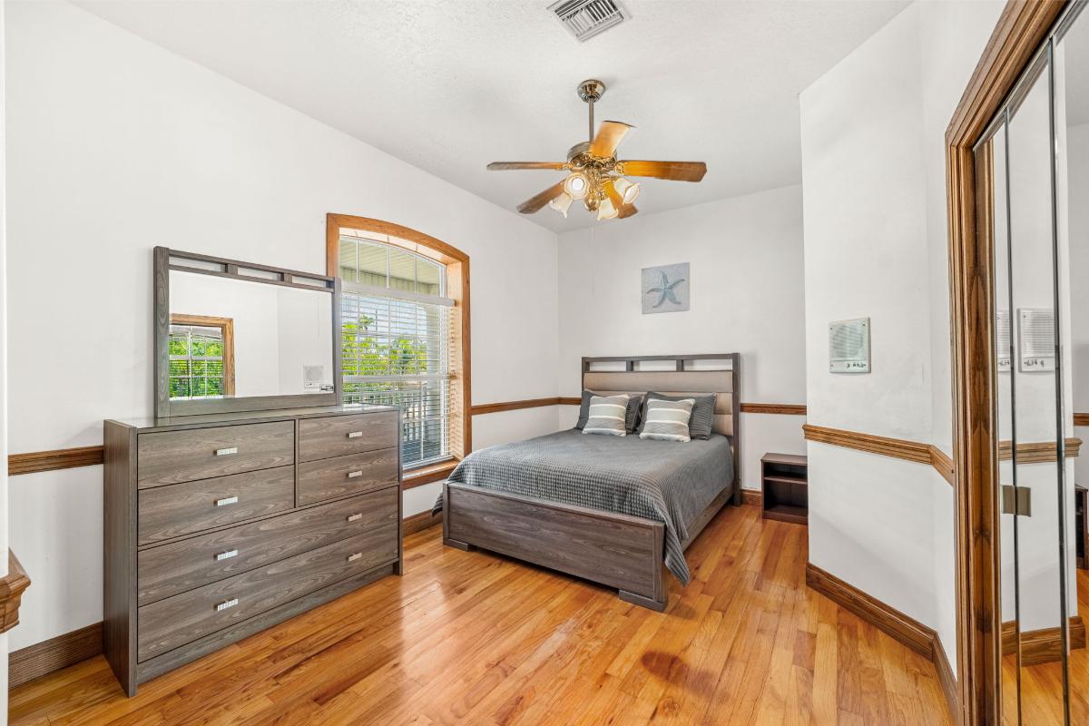 Bedroom with hardwood floor and glass windows.