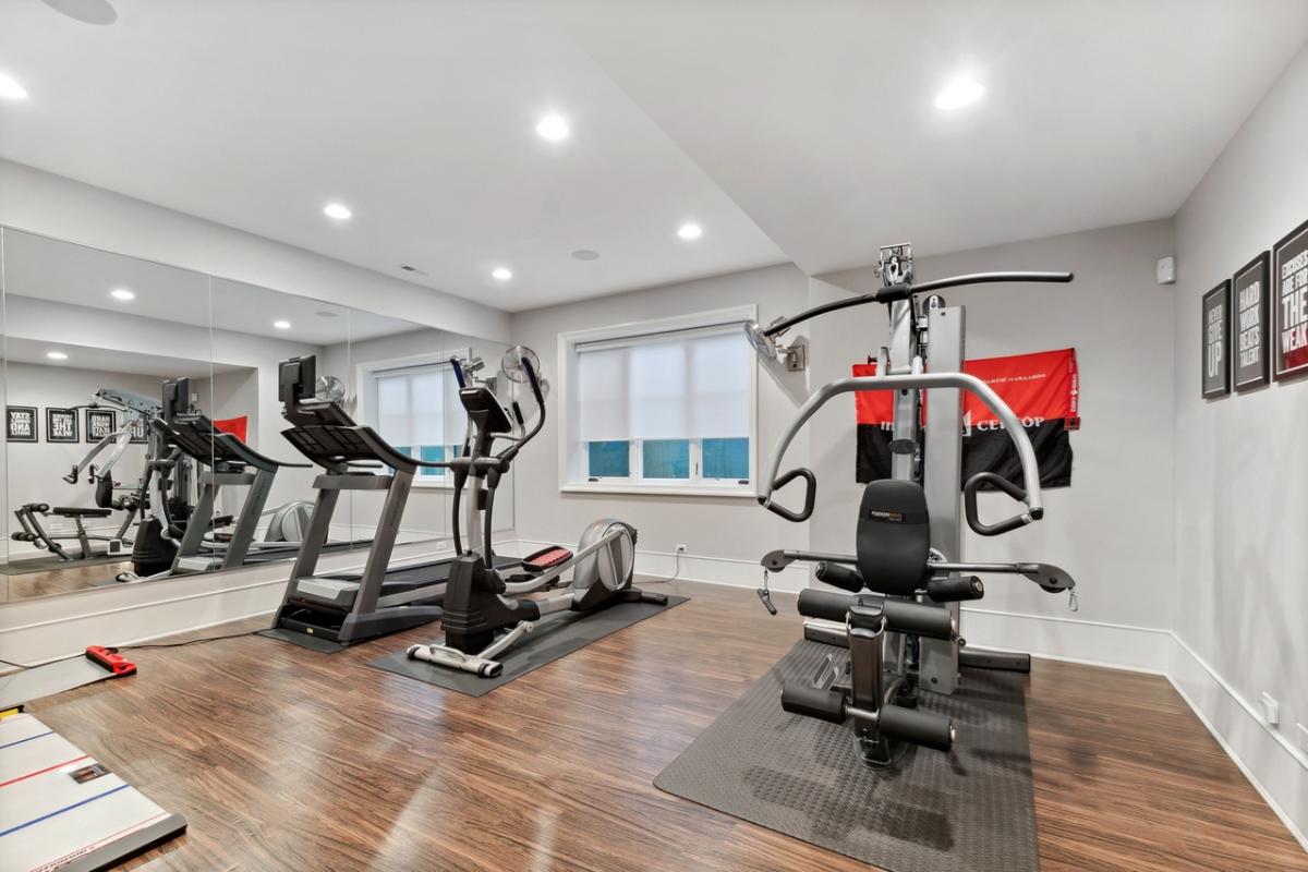 Home gym with a large mirror.