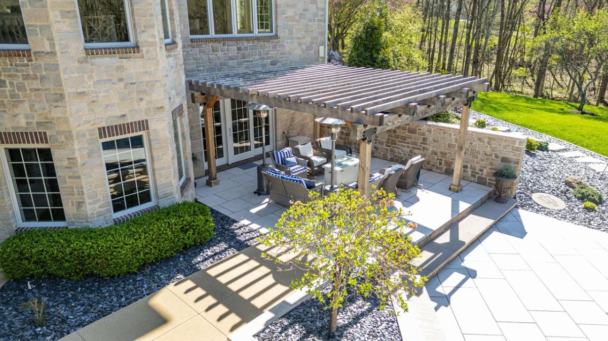Pergola with tables and chairs.