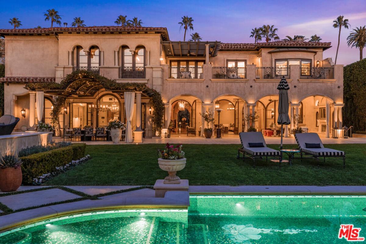 Rear view of the mansion with a pool.