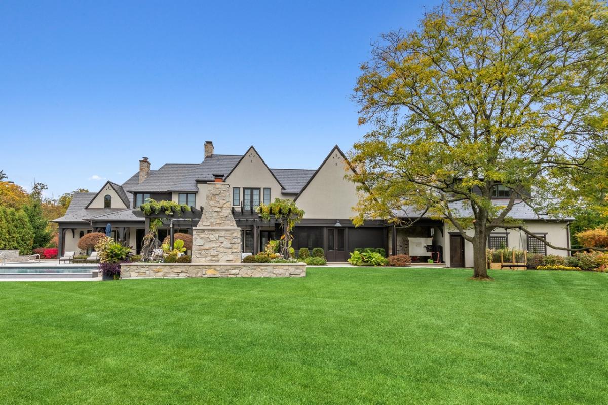 Front view of the house with a large green lawn.