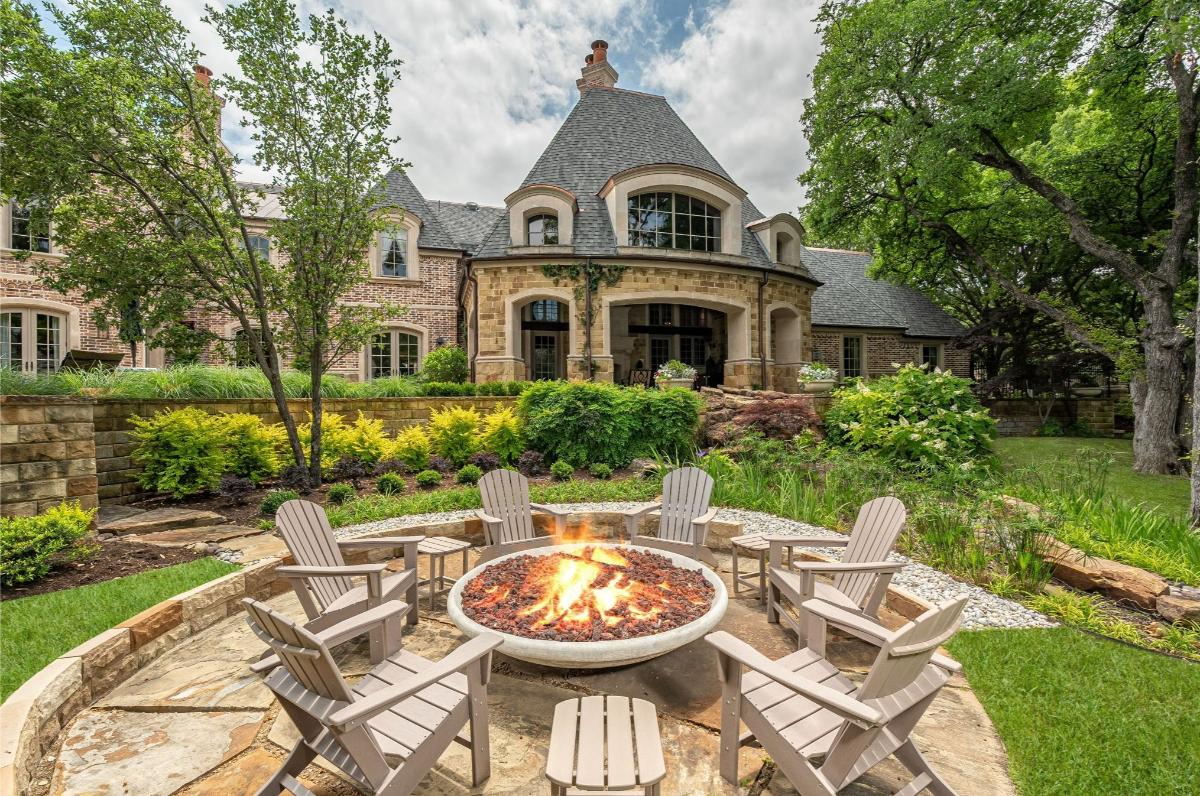Rear view of the mansion with a fire pit.