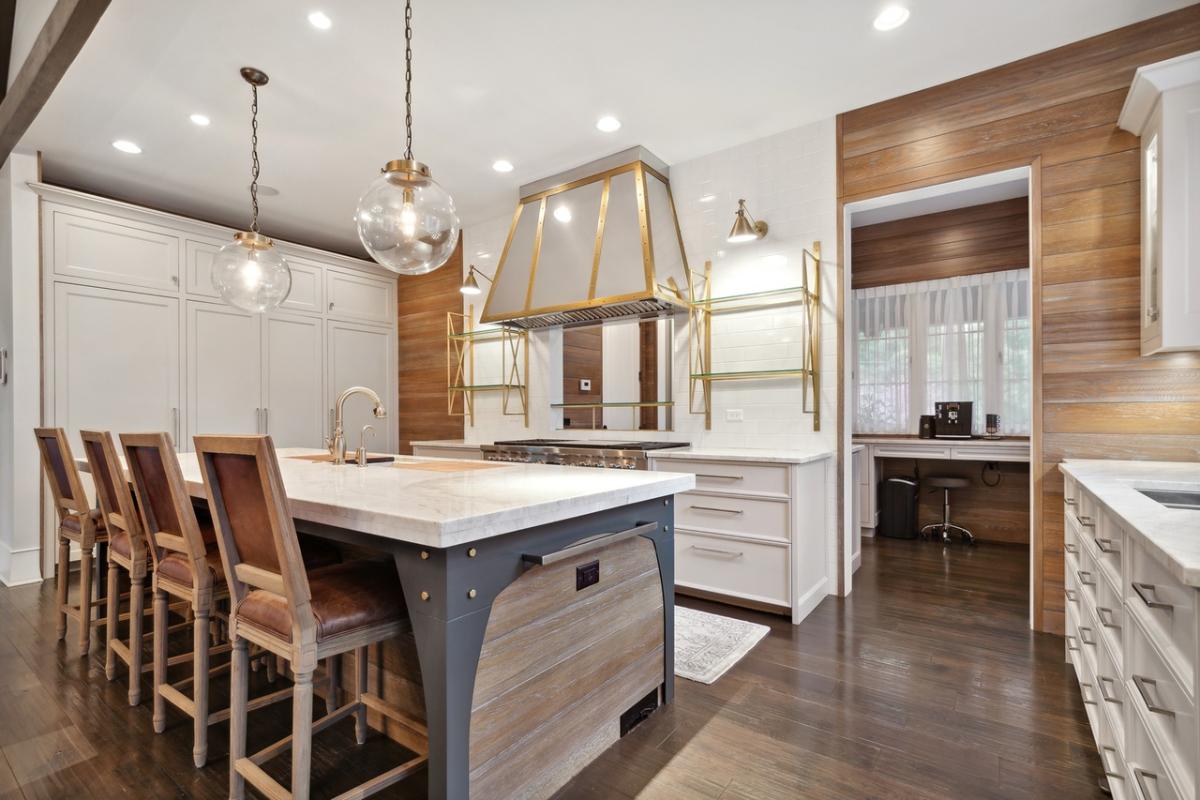 Kitchen with a breakfast counter, custom lighting and custom cabinetry.
