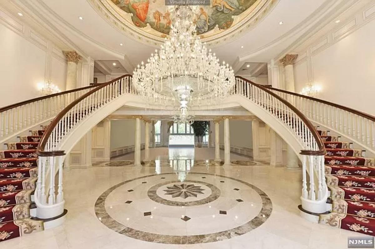 Foyer with a chandelier and stairs.