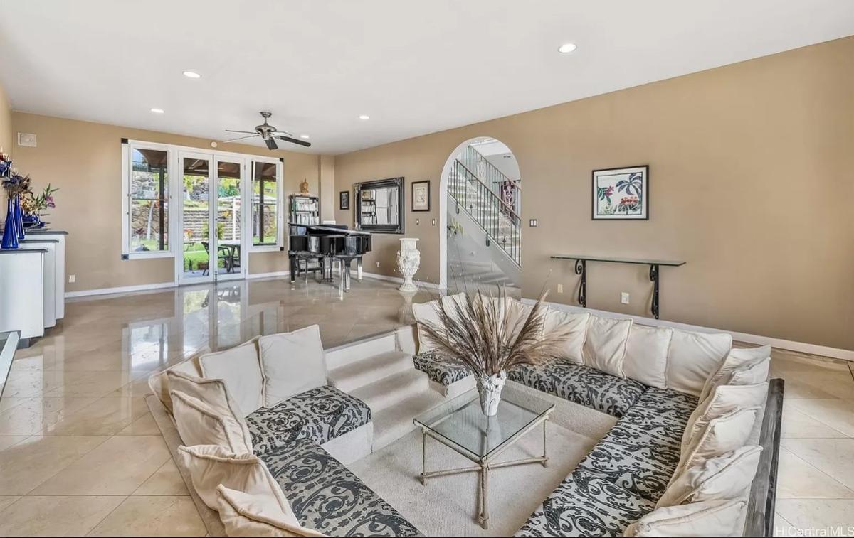 Living room with tile flooring and a piano.